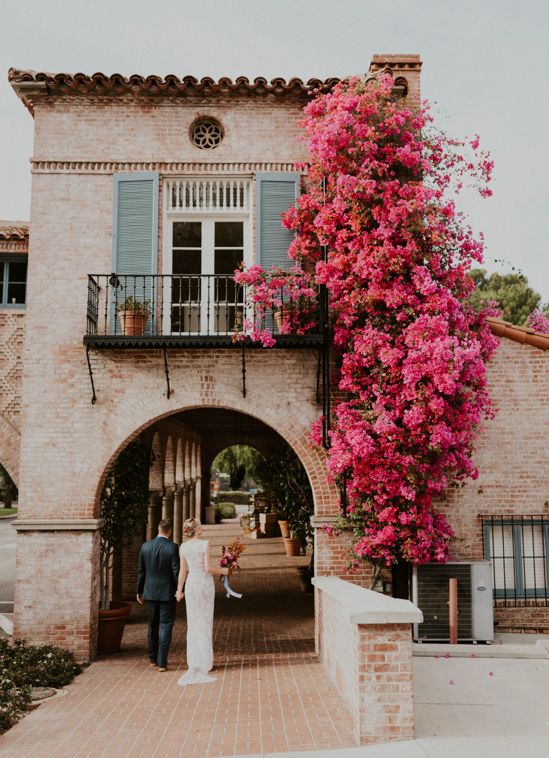Blue Moon Dream DIY Wedding at Wayfarers Chapel in Palos Verdes, CA bride and groom looking at bougainvilliea